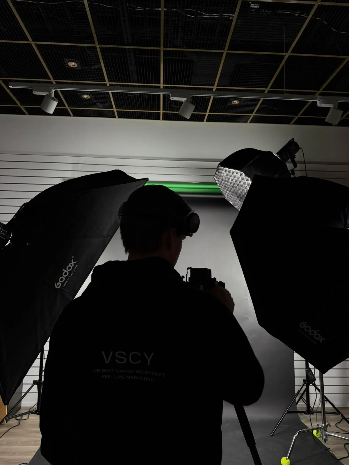 A photographer among the lights on a shoot day in the studio
